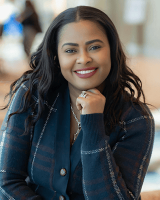 Smiling woman resting chin on hand